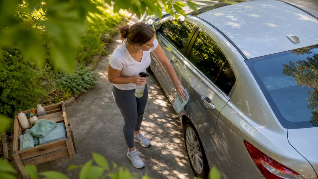 Woman washing car with eco-friendly products
