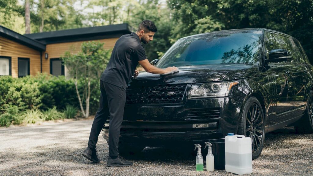 Professional cleaning car on driveway